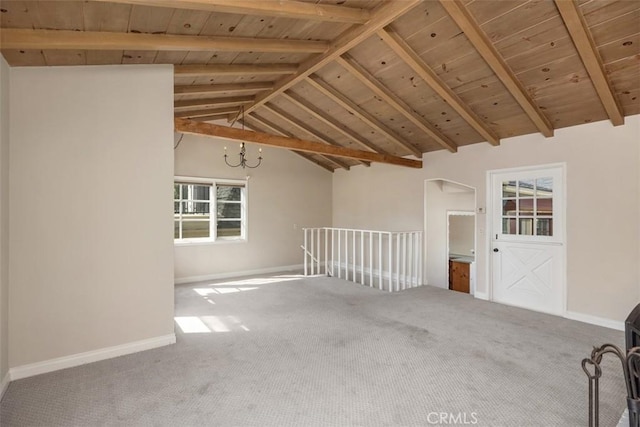 carpeted spare room featuring vaulted ceiling with beams, a notable chandelier, and wood ceiling