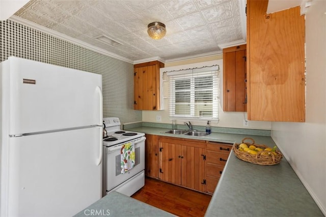 kitchen featuring sink, white appliances, ornamental molding, and hardwood / wood-style flooring