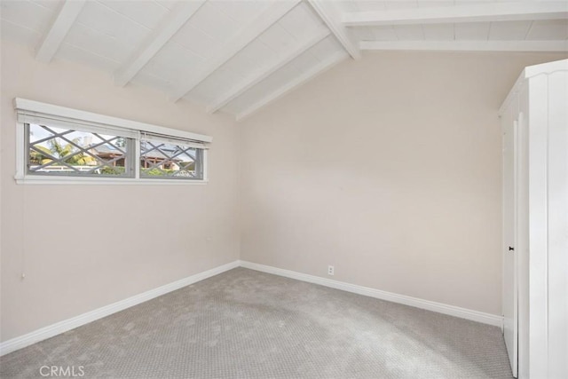 unfurnished bedroom with lofted ceiling with beams and carpet