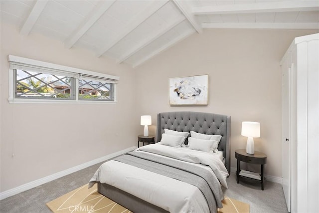 bedroom with lofted ceiling with beams and carpet flooring