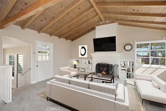 carpeted living room featuring lofted ceiling with beams, a brick fireplace, and wooden ceiling