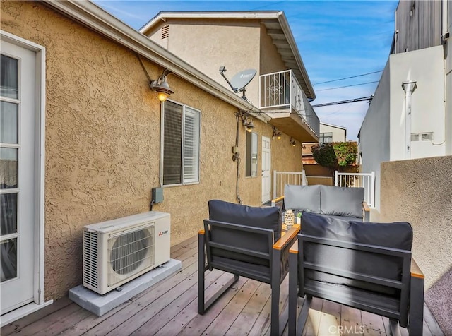 wooden terrace featuring ac unit and fence