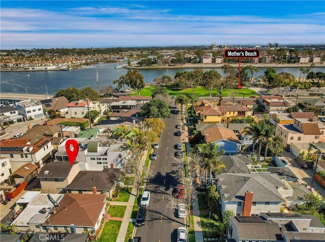 drone / aerial view featuring a water view and a residential view