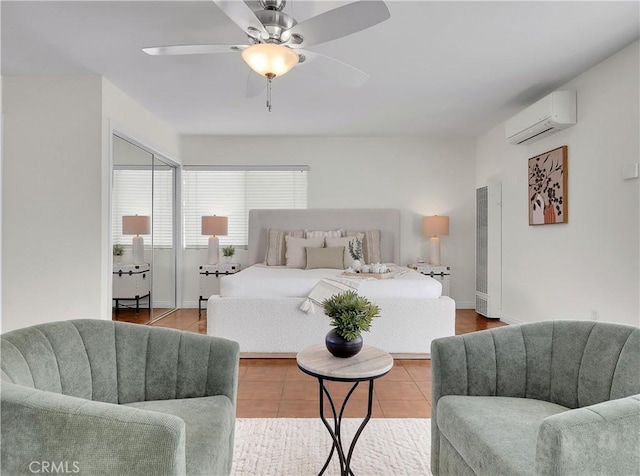 bedroom with baseboards, a ceiling fan, and a wall mounted AC