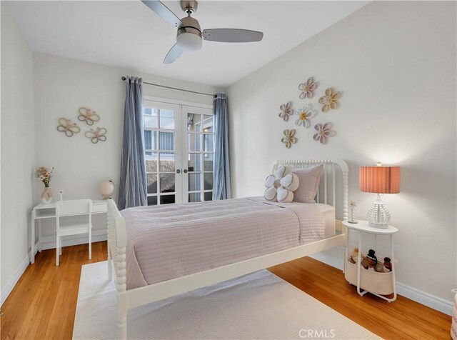 bedroom with french doors, baseboards, ceiling fan, and wood finished floors