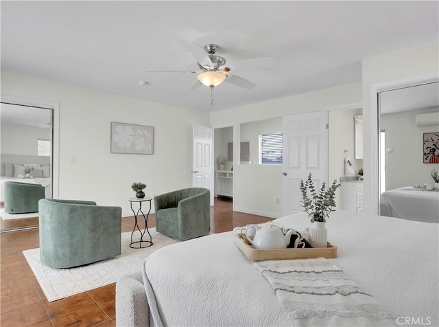 bedroom featuring a wall mounted air conditioner and a ceiling fan