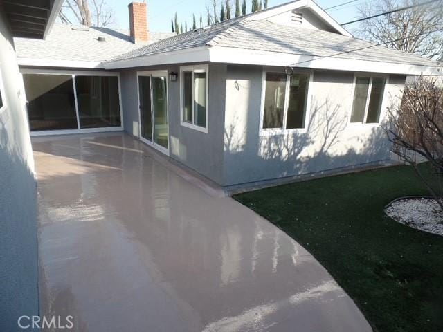 view of side of property featuring a patio