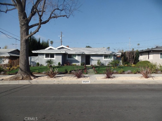 ranch-style house with a front lawn