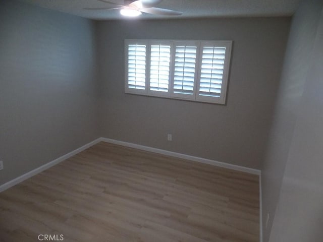 empty room featuring ceiling fan and wood-type flooring