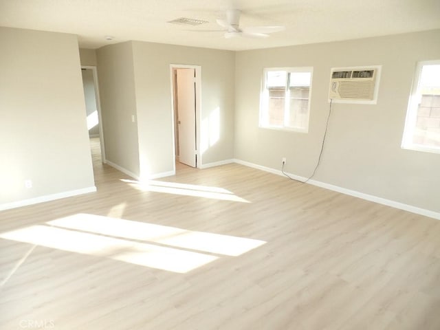 unfurnished bedroom featuring ceiling fan, light hardwood / wood-style floors, and a wall mounted AC