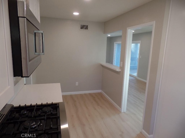 interior space featuring cooktop and light wood-type flooring