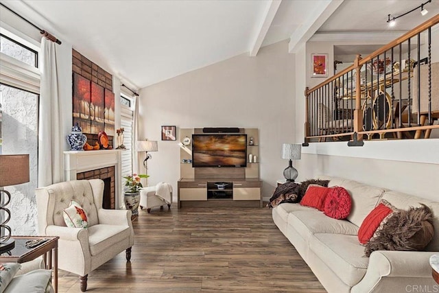 living room with a fireplace, vaulted ceiling with beams, stairs, and wood finished floors