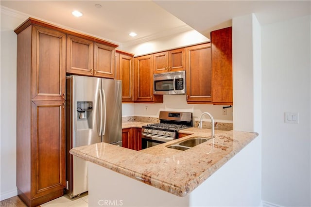 kitchen with sink, crown molding, stainless steel appliances, light stone countertops, and kitchen peninsula