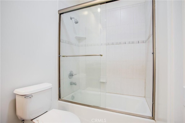 bathroom featuring shower / bath combination with glass door and toilet