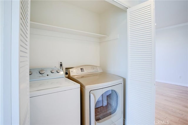 washroom featuring light hardwood / wood-style flooring and washing machine and dryer