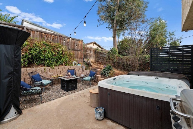 view of patio featuring a hot tub and a fire pit