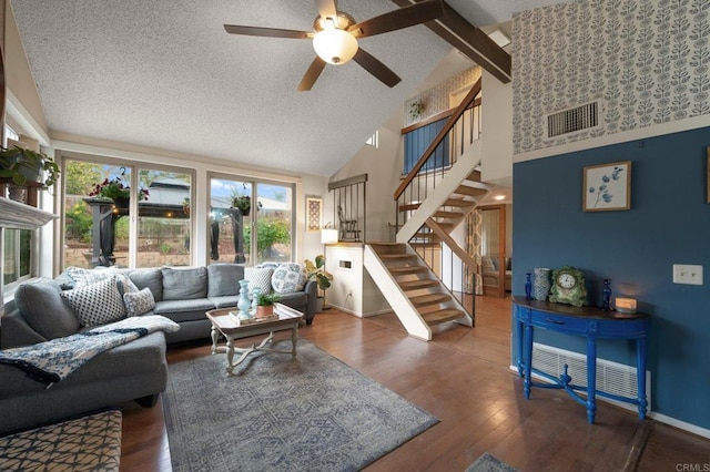 living room featuring ceiling fan, high vaulted ceiling, dark hardwood / wood-style floors, and a textured ceiling