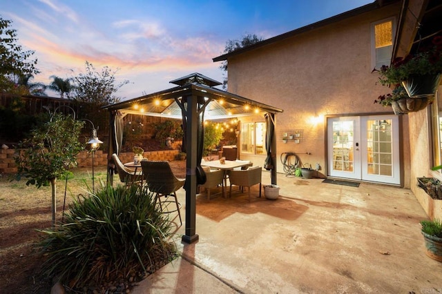 patio terrace at dusk with french doors and a gazebo