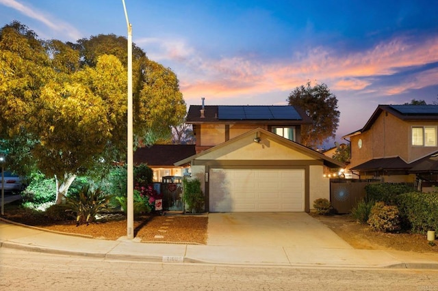 view of front of home with a garage and solar panels