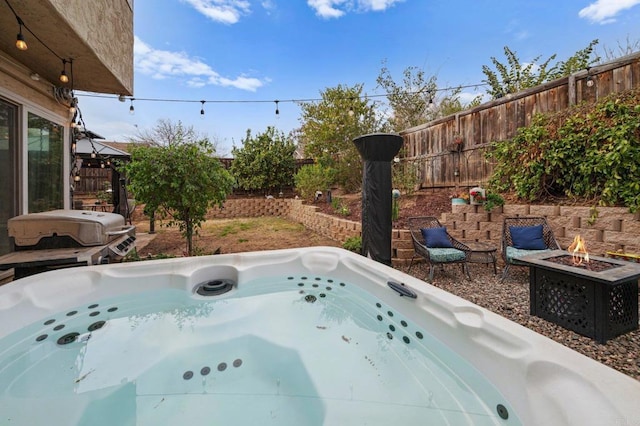 view of pool featuring a hot tub, a grill, and an outdoor fire pit