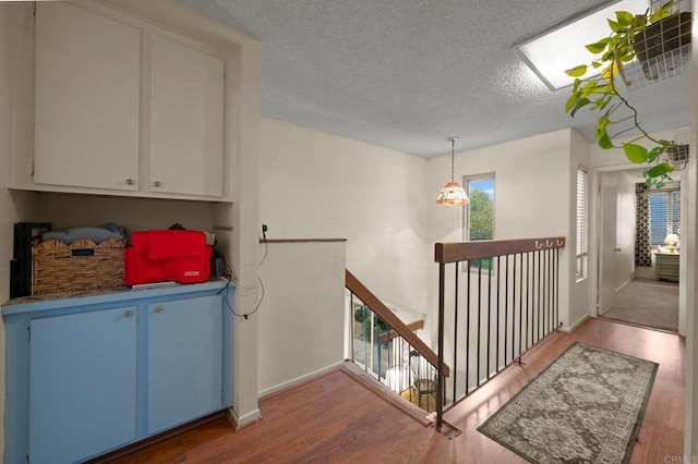 interior space with hardwood / wood-style flooring and a textured ceiling