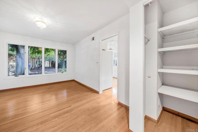 interior space featuring light wood-style floors, visible vents, and baseboards