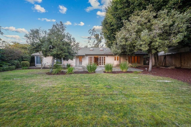 back of property featuring a yard, a patio area, and fence