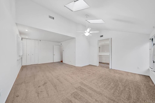 unfurnished bedroom featuring a skylight, visible vents, connected bathroom, and carpet flooring