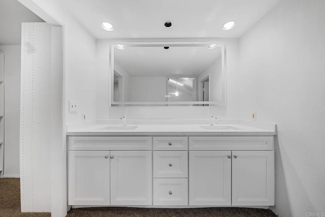 full bath with recessed lighting, a sink, and double vanity