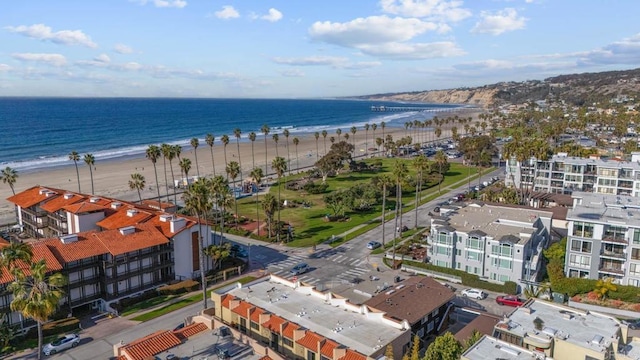 birds eye view of property with a beach view and a water view