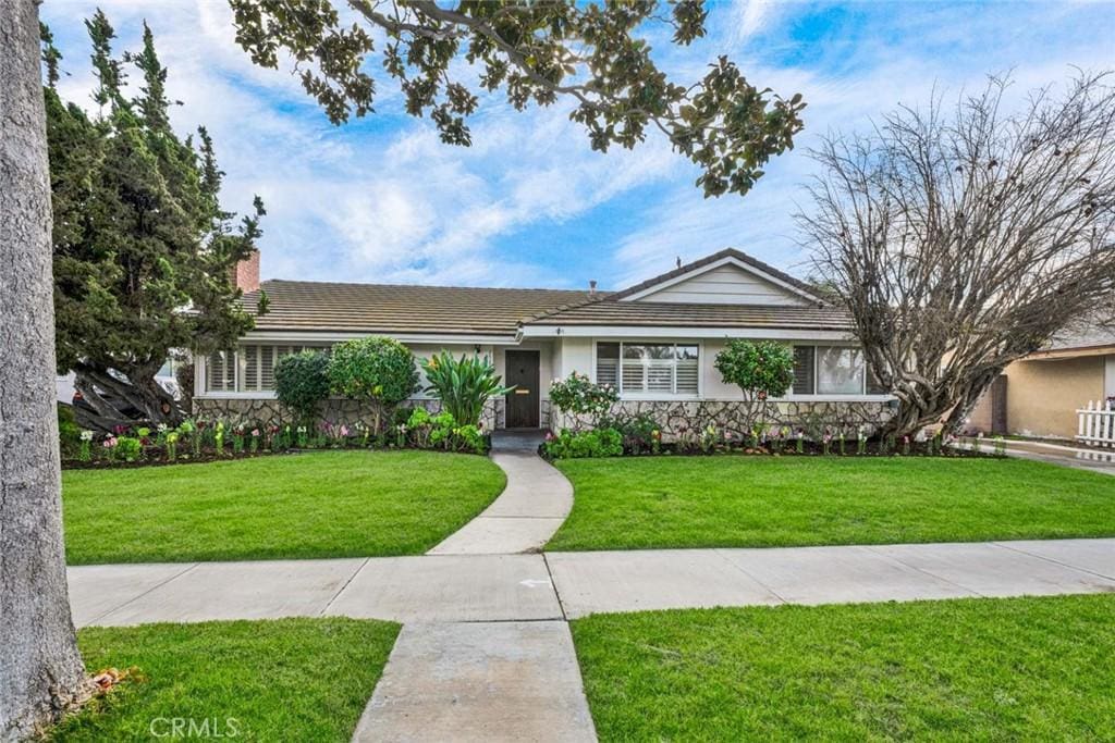 ranch-style house with a front lawn