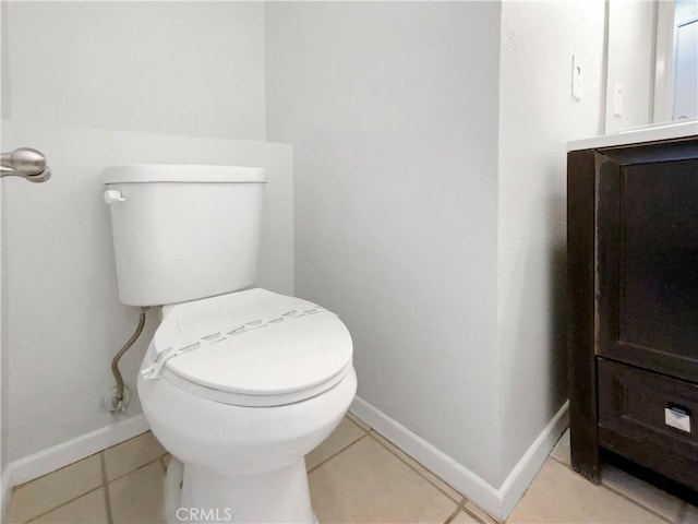 bathroom featuring vanity, tile patterned flooring, and toilet