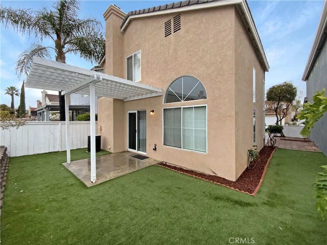 rear view of house featuring a patio area, a yard, and a pergola