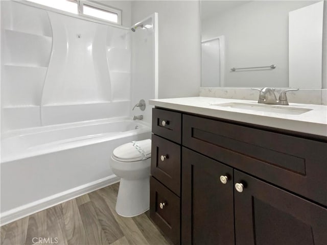 full bathroom featuring hardwood / wood-style flooring, vanity, toilet, and  shower combination