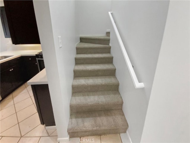 stairway with tile patterned flooring