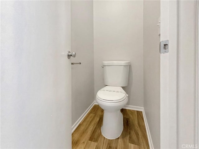 bathroom with wood-type flooring and toilet