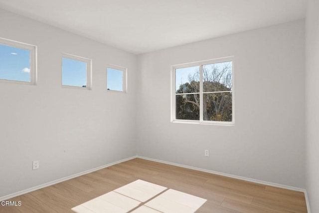 spare room featuring light hardwood / wood-style flooring