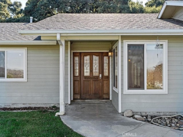 property entrance with roof with shingles