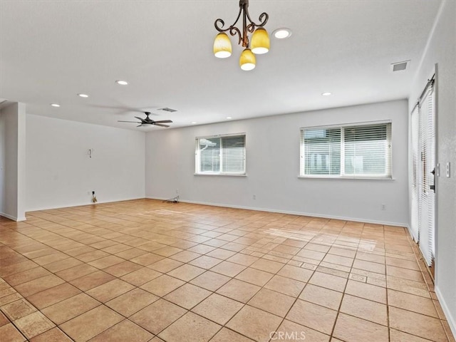 unfurnished living room featuring light tile patterned floors, recessed lighting, visible vents, and ceiling fan with notable chandelier