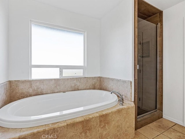 full bathroom with a garden tub, tile patterned flooring, and a shower stall