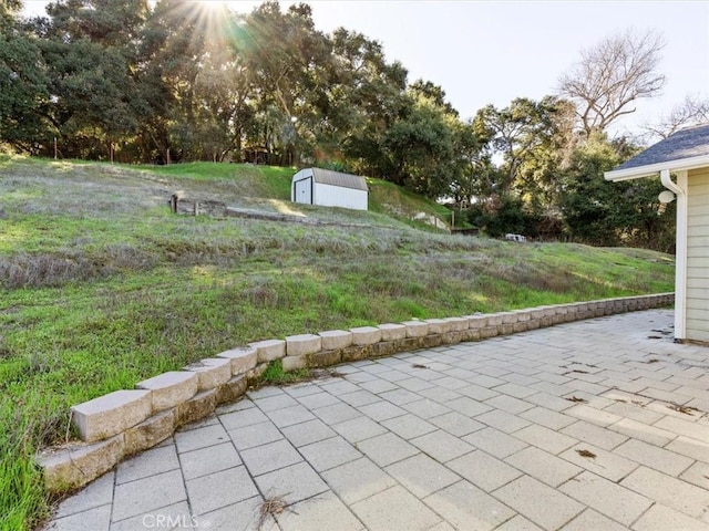 view of patio featuring an outbuilding and a shed