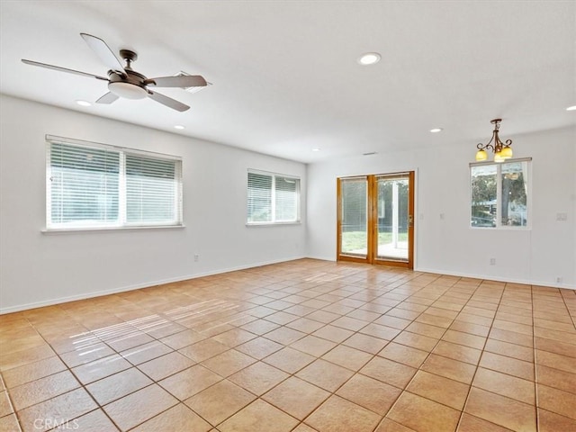 spare room with recessed lighting, ceiling fan with notable chandelier, baseboards, and light tile patterned flooring