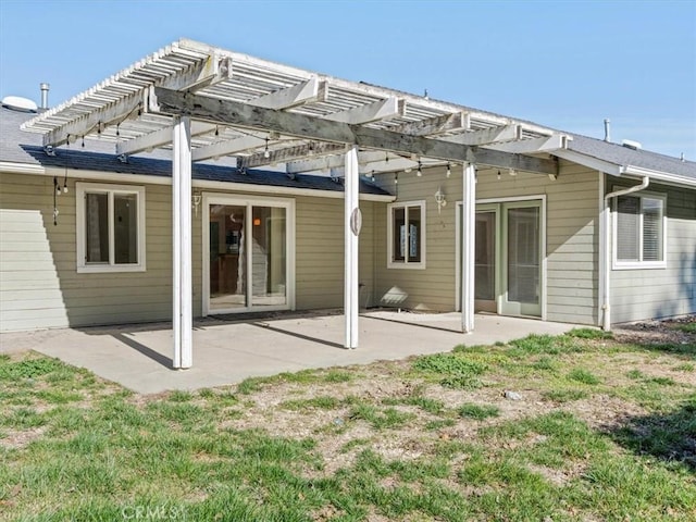 back of house with a patio, a lawn, and a pergola