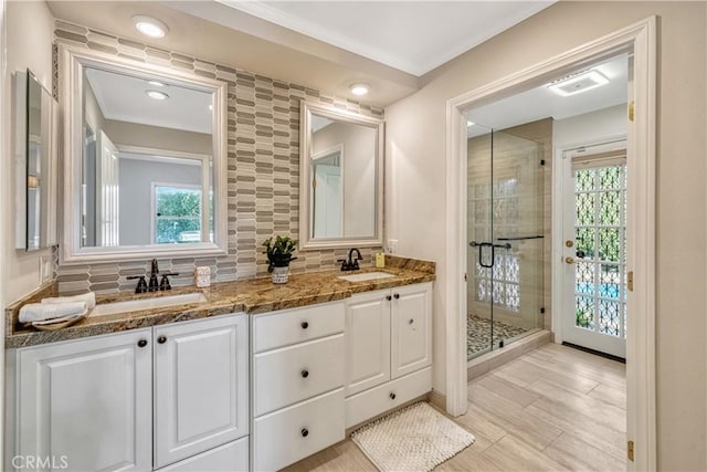 bathroom featuring a sink, a wealth of natural light, and a stall shower