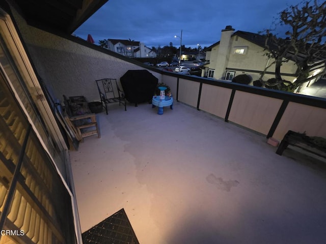 patio terrace at dusk with a balcony