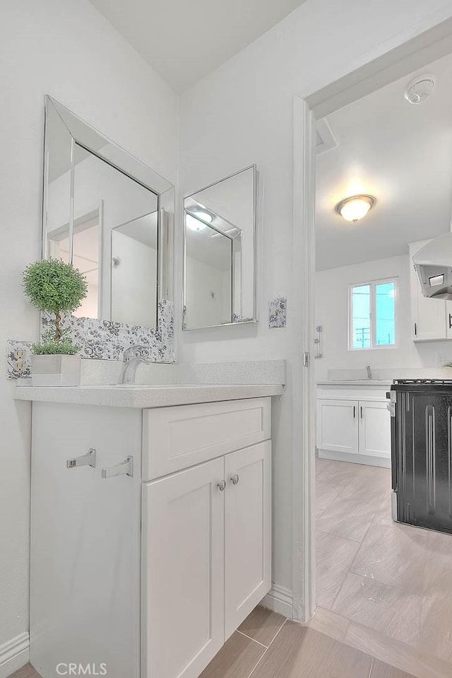 bathroom featuring two vanities and a sink