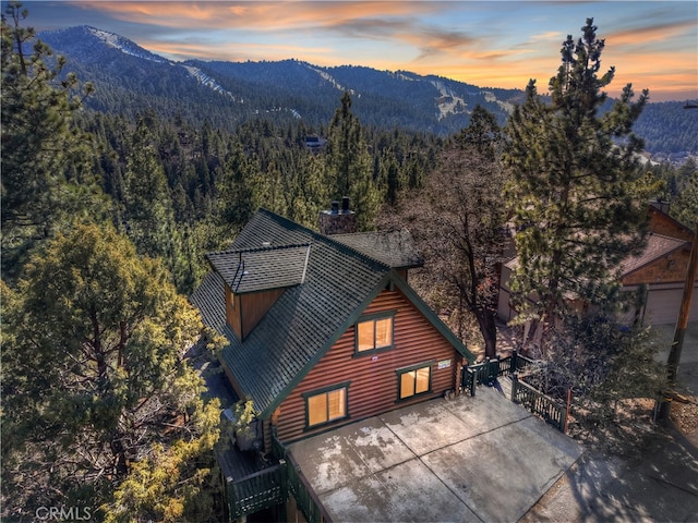 back house at dusk featuring a mountain view