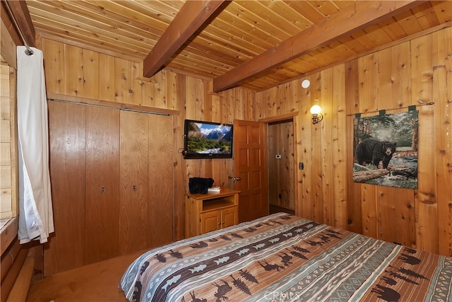 bedroom with beam ceiling, wooden walls, wooden ceiling, and a closet