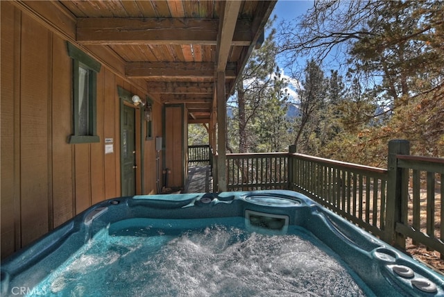 wooden terrace with a hot tub