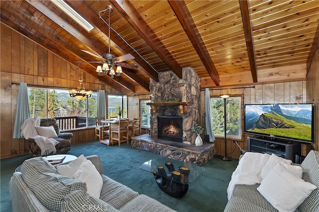 unfurnished living room featuring a fireplace, wooden walls, vaulted ceiling with beams, carpet, and wooden ceiling